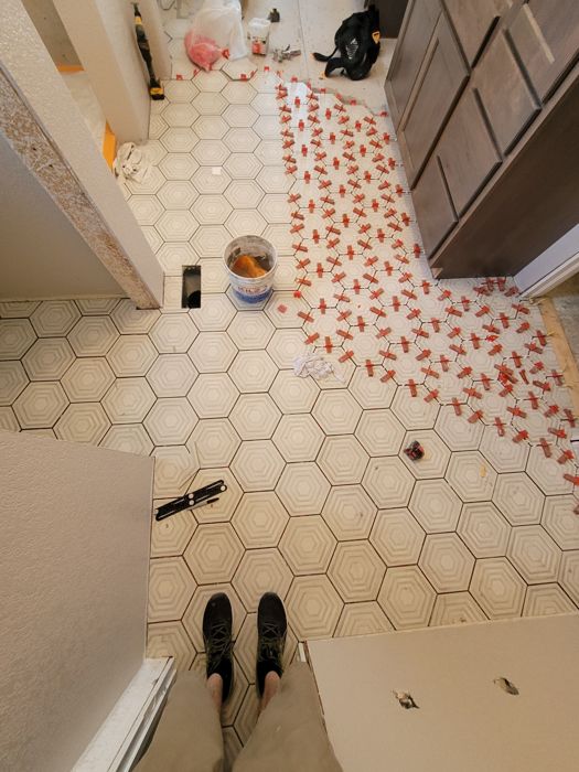 Hexagon tile floor install with leveling spacers